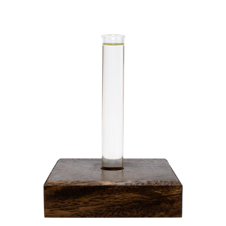Clear beaker with Spa Massage Oil on a wooden square base against a white background
