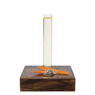Essential Tune Up Blend in a glass beaker on a wooden base with natural ingredients