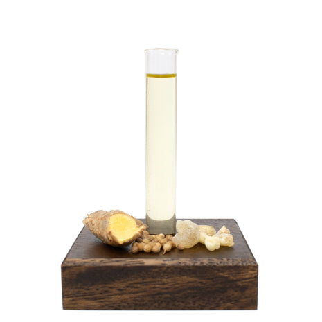 Glass beaker with Beard & Mustache Oil on a wooden base with ginger root and natural ingredients.
