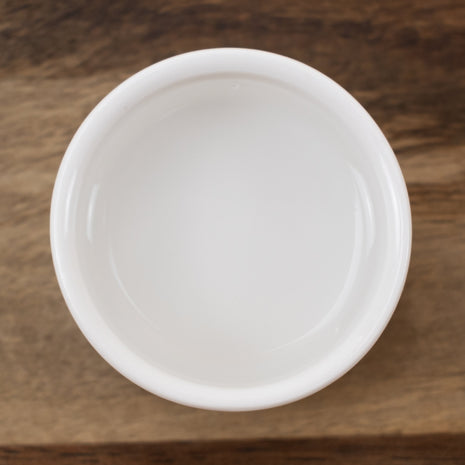 White ceramic bowl with Cucumber Distillate on a wooden surface