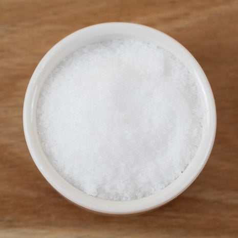 OptiMSM (MSM Methylsulfonylmethane USA) in a small ceramic bowl on a wooden surface