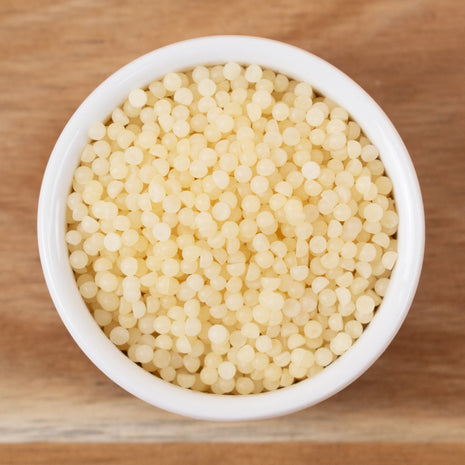 White bowl filled with Beeswax Yellow on a wooden surface